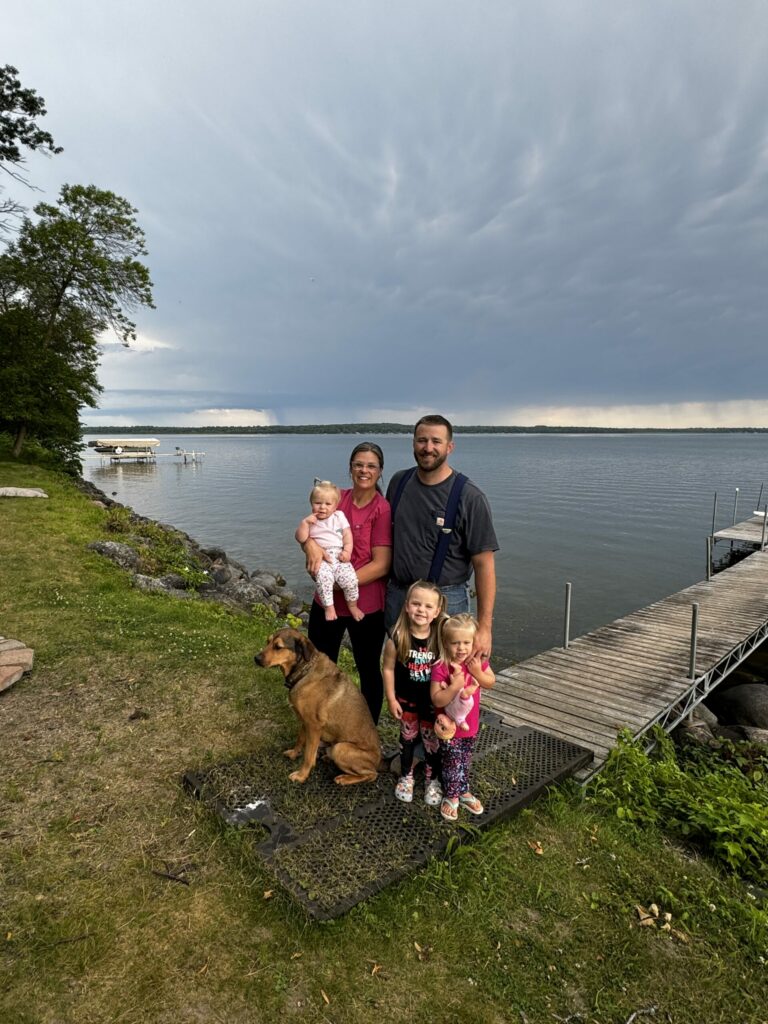 Family on vacation standing near a lake